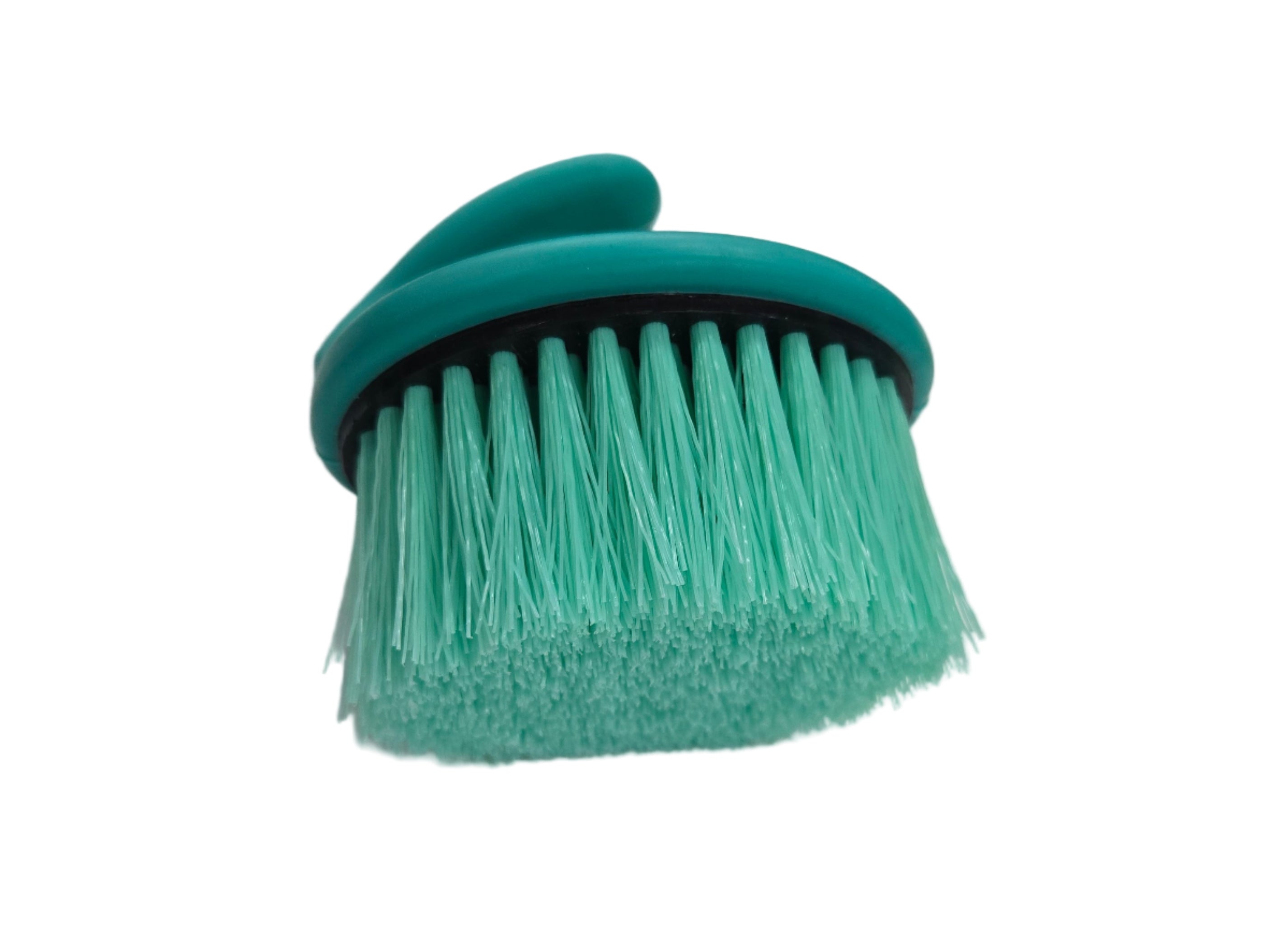 Green brush with a black handle on a white surface